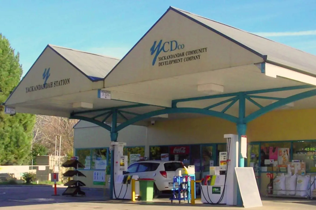 Yackandandah Community Development Company (YCDCo) petrol station showcasing a car at the pump, fuel dispensers, and surrounding infrastructure, representing a community-owned cooperative in regional Australia.